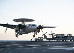 An E-2D Advanced Hawkeye assigned to Air Test and Evaluation Squadron 20 lands aboard the aircraft carrier USS Gerald R. Ford (CVN-78)., marking the first time an E-2D had landed aboard the Ford. CVN-78 is conducting aircraft compatibility testing to continued testing the EMALS and AAG launch and recovery systems. (Photo: U.S. Navy)